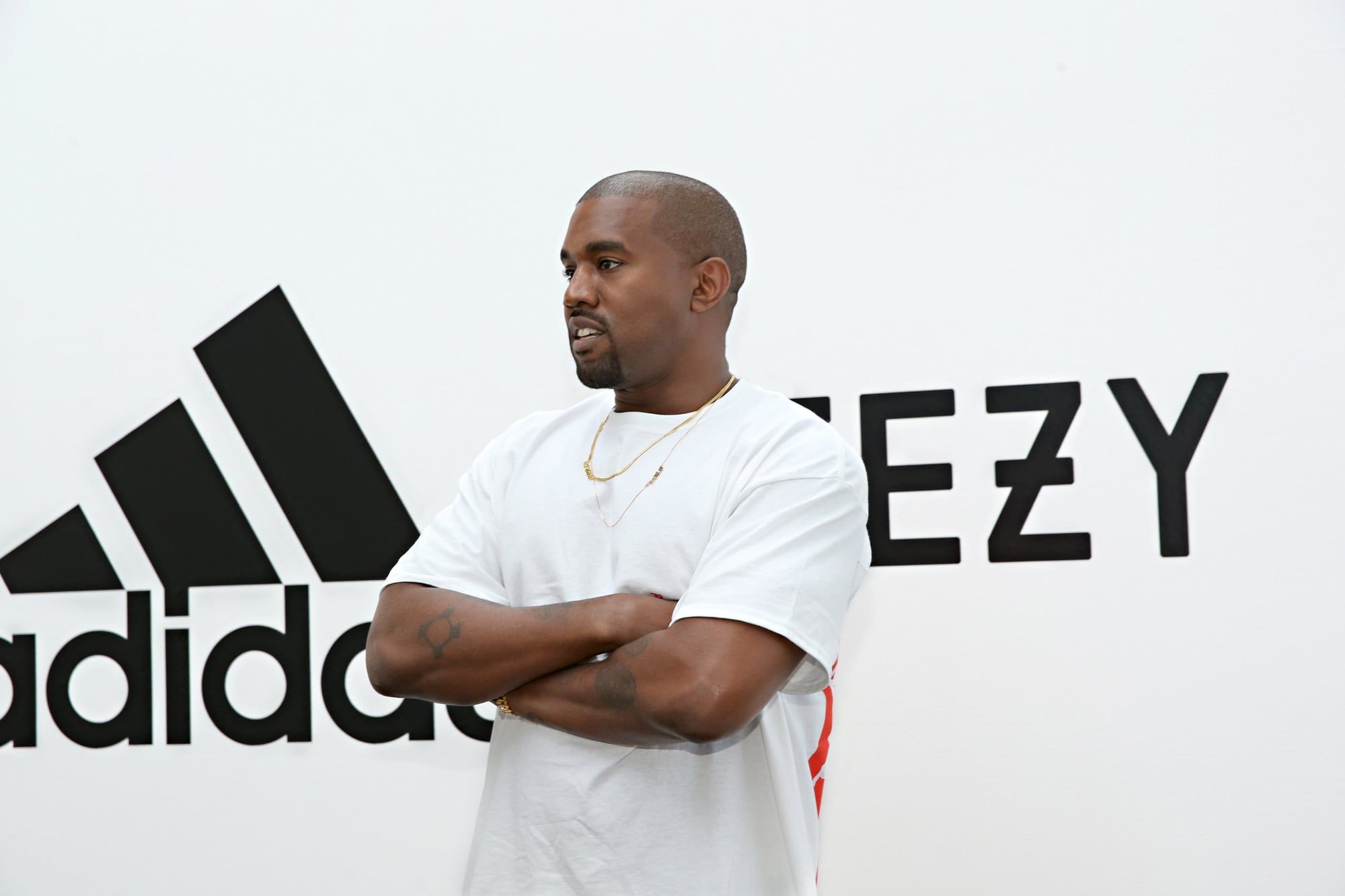 Ye lost Balenciaga, CAA, Gap and adidas in five days of October 2022. Ye in a white tee in front of an adidas and Yeezy backdrop, Milk Studios, Hollywood, 28 Jun 2016.