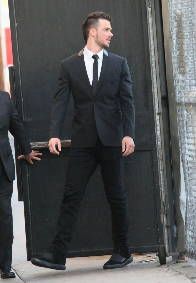 Kris Bryant won the World Series, then wore black Yeezy 750s with a suit. Kris Bryant in a black suit and tie walking through the stage door, all-black Yeezy 750 Boost with the strap visible, Los Angeles, 7 Nov 2016.