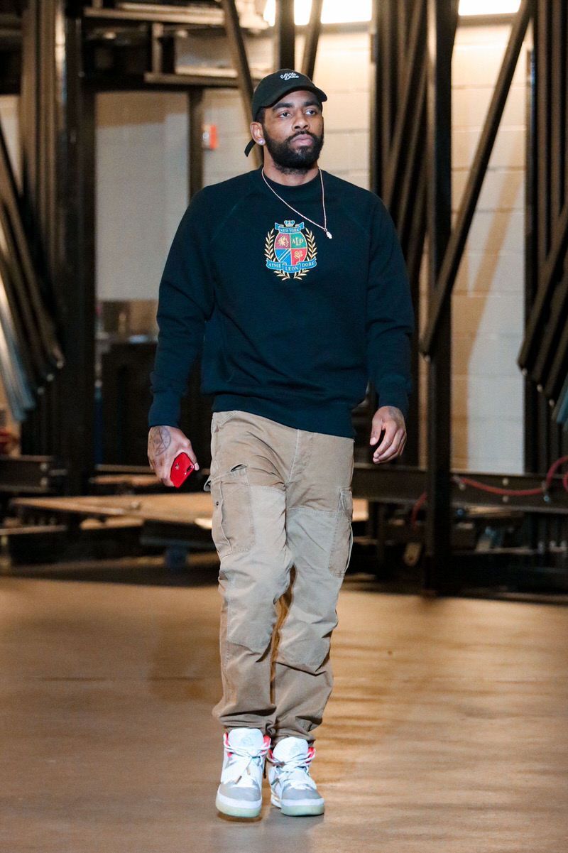 Kyrie Irving had his own Nike shoe and still walked in wearing Air Yeezy 2s. Kyrie Irving full length in the tunnel, navy crew, khaki cargos, Nike Air Yeezy 2 Pure Platinum, American Airlines Center, Dallas, 24 Nov 2018.