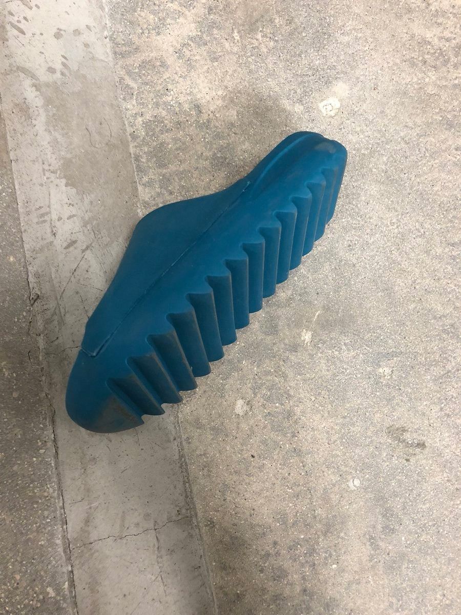 Ye posted the first Yeezy Slide in 2018 and called it a rough draft. The blue slide sample with the jagged sole, on a concrete floor.