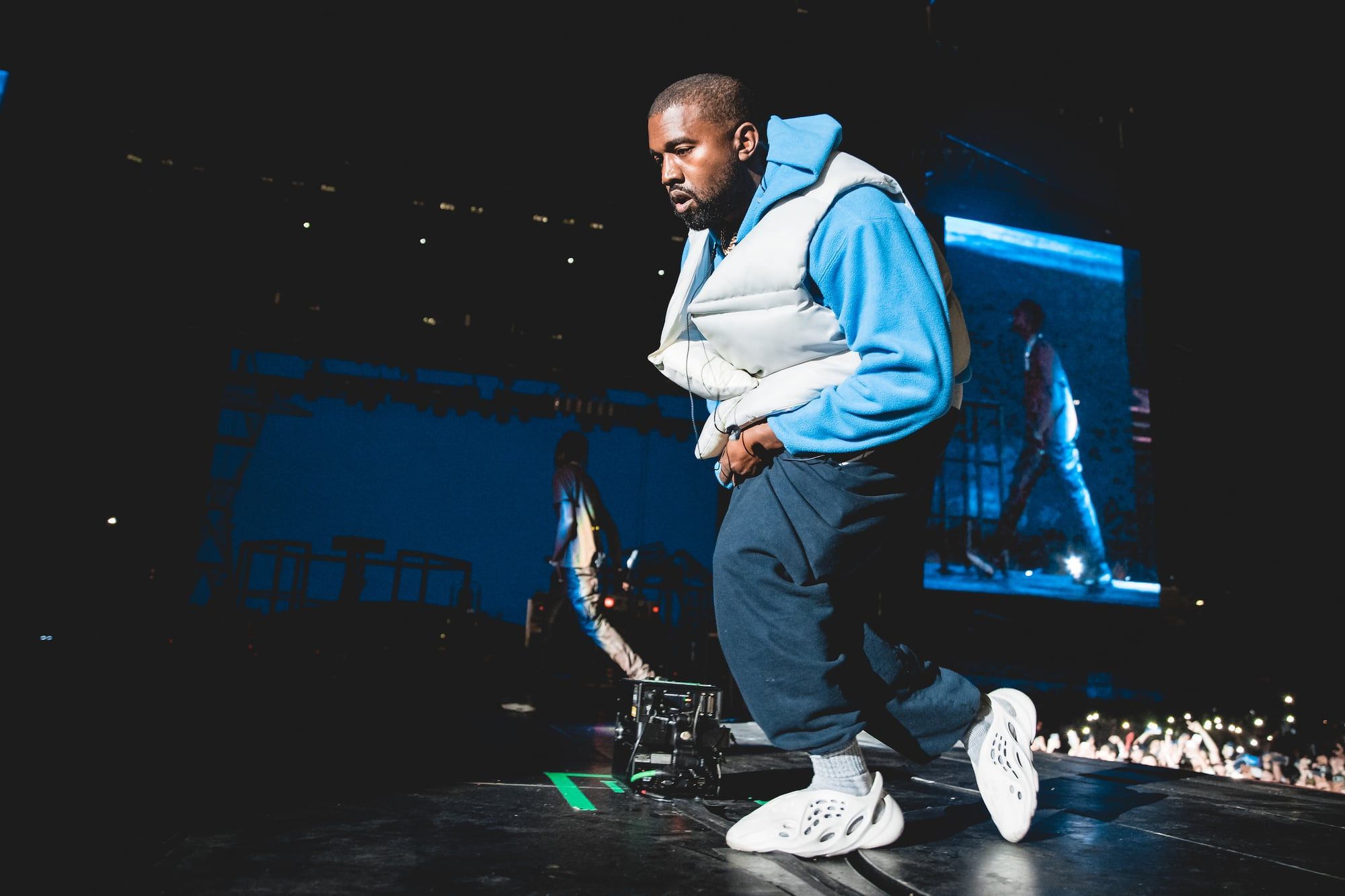 Ye took Foam Runners to Astroworld seven months before they dropped. Ye on stage at Astroworld Festival, Houston, Nov 2019: blue hoodie, cream gilet, navy joggers, white pre-release Foam Runners.