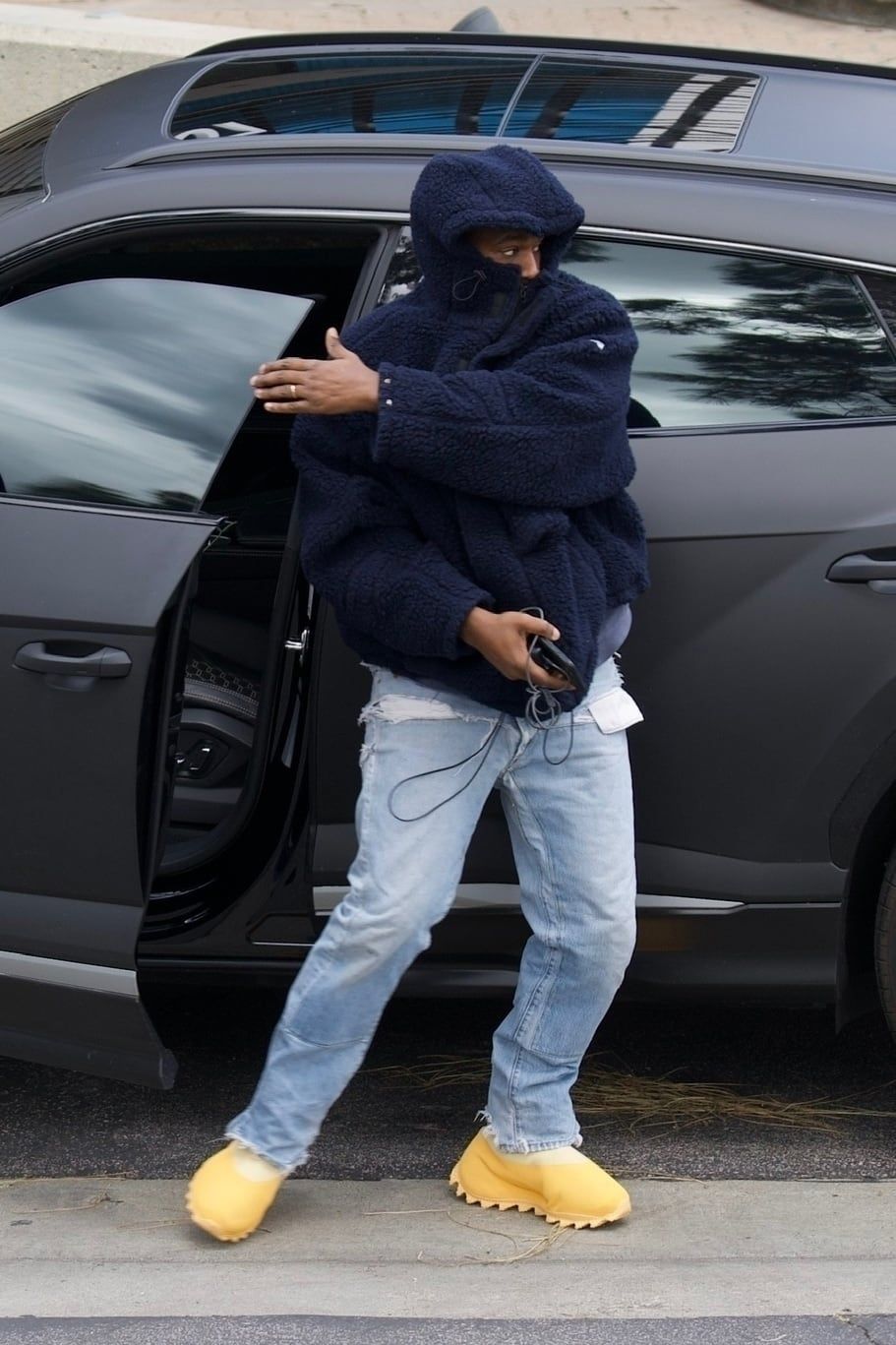 Ye wore a yellow Season 8 boot to the office 19 months before it dropped. Ye outside Yeezy's Calabasas office in the unreleased yellow boot, navy fleece, washed denim.