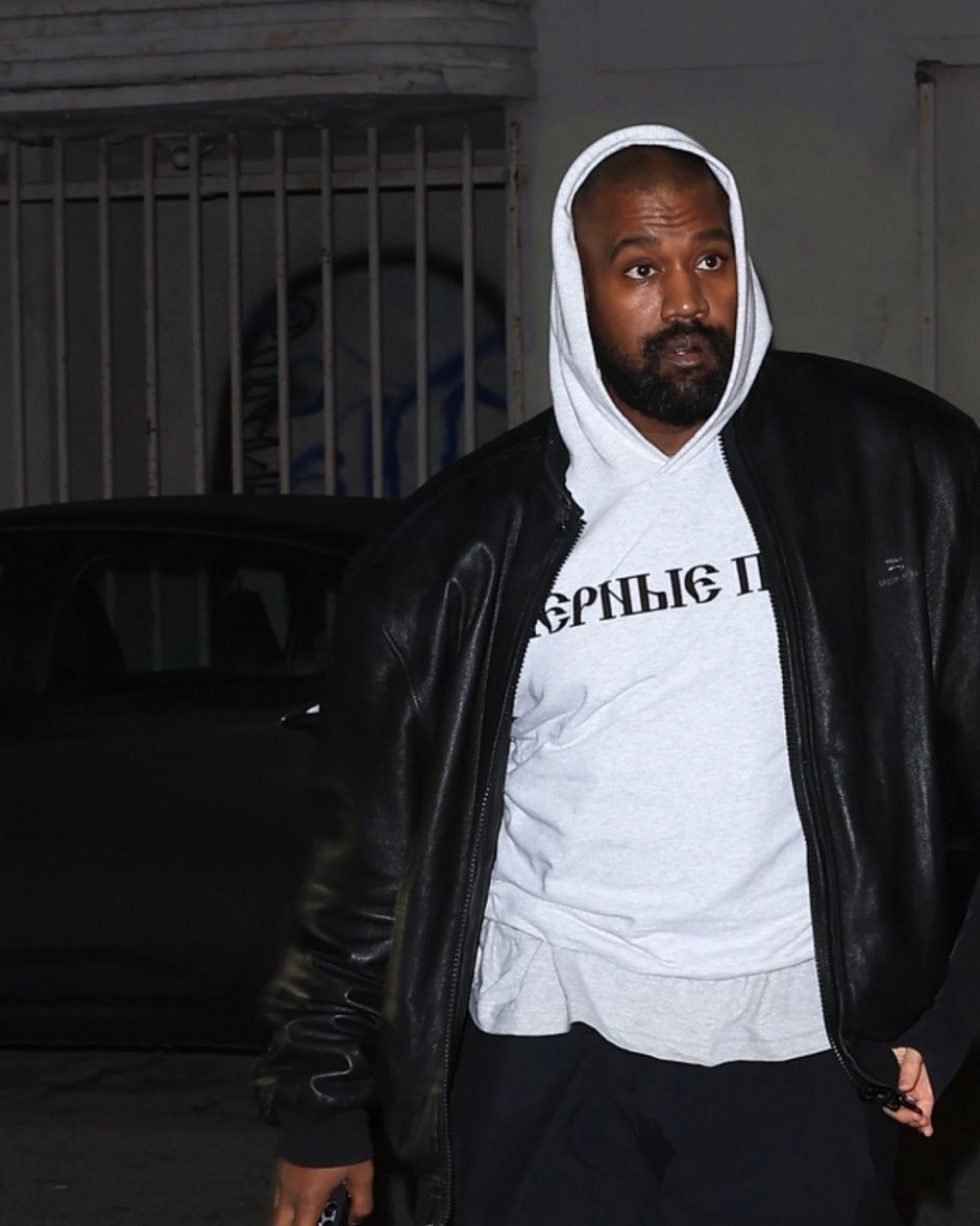The Black Dogs hoodie went on sale at 1:24pm. Ye wore it that night. Heather grey, Ye on 8 Mar 2024, cropped to Ye.