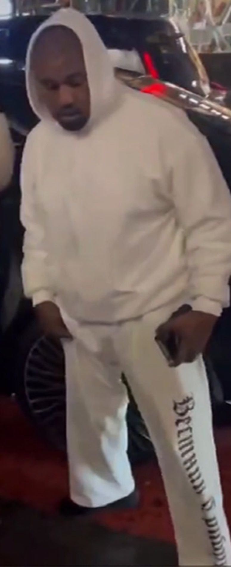 Ye wore the Herald Tribune down one leg in Tokyo, two months early. White, Ye in the SP-01, Tokyo, 30 Oct 2024.
