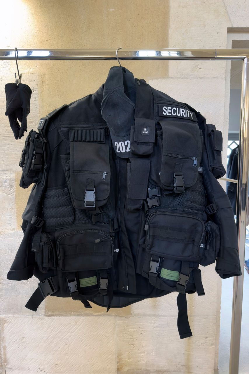 Ye opened Balenciaga’s mud show 19 days before the house cut ties with him. The look 1 SECURITY jacket on the rack at Balenciaga's re-see, front, with the cap and gloves; MFH tag on a chest pouch.