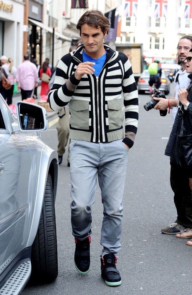 Roger Federer walked Bond Street in Air Yeezy 2s, then won Wimbledon. Federer in the street beside a parked car, photographers behind him, Air Yeezy 2 Solar Red, 19 Jun 2012.