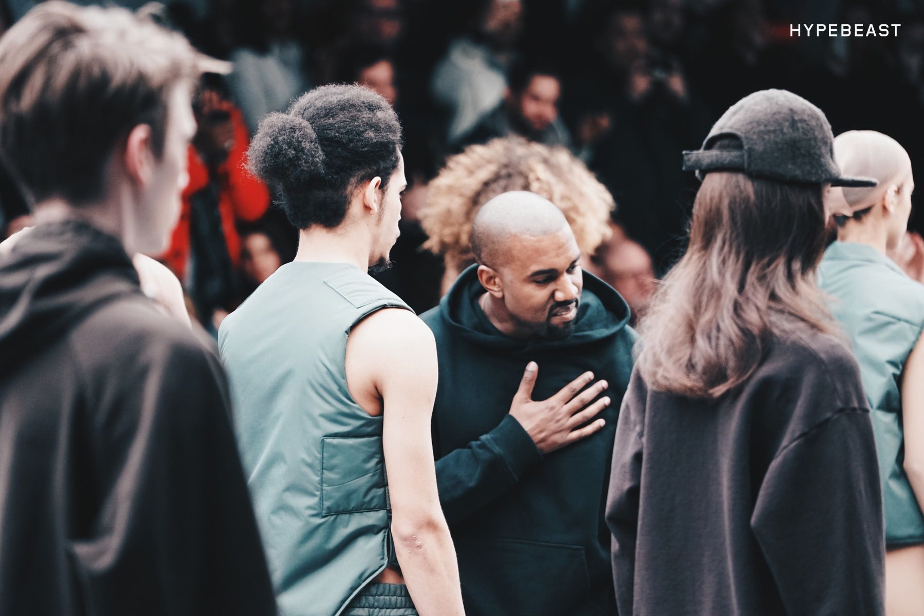 Yeezy Season 1 had Beyoncé front row. Ye bowed in a plain hoodie.. Ye, hand on his chest, among the models at the Yeezy Season 1 show, 12 Feb 2015.