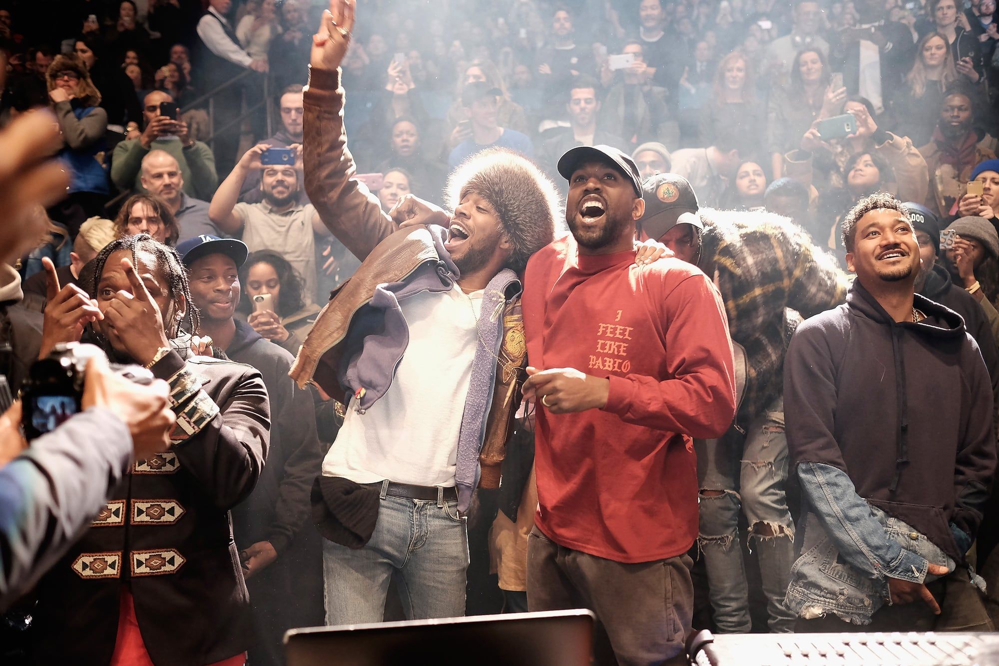 Ye sold out Madison Square Garden with an album nobody had heard. Ye celebrating on the floor with Kid Cudi, full 'I feel like Pablo' long sleeve visible, 11 Feb 2016.