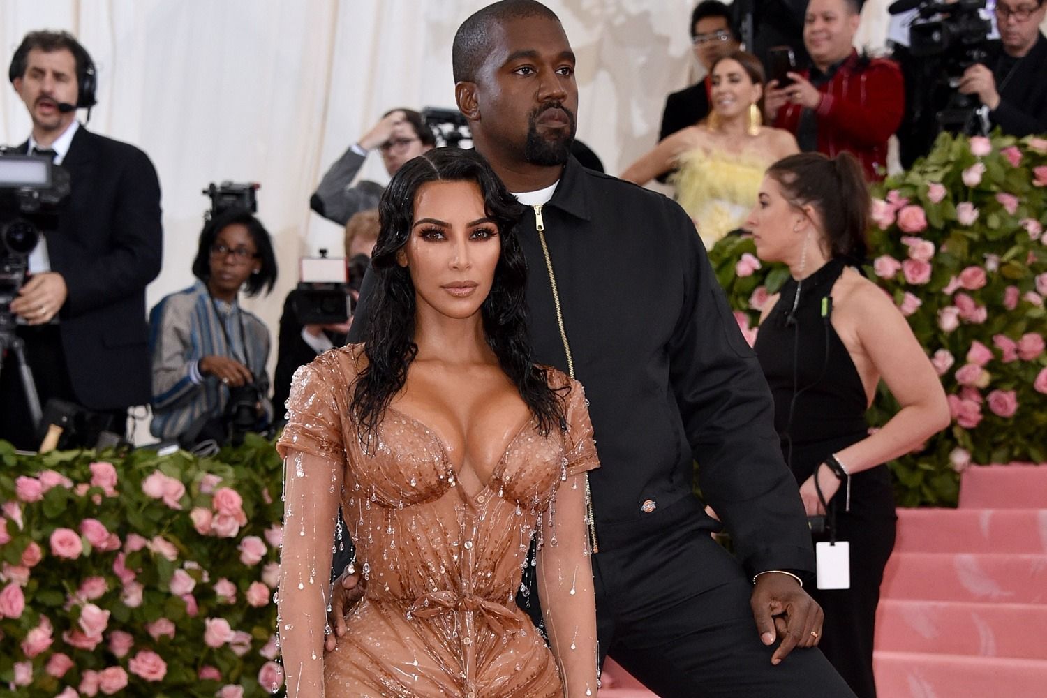 The Met asked for camp. Ye showed up in a Dickies work jacket. Ye on the Met steps in the Dickies jacket, Kim in front, 6 May 2019.