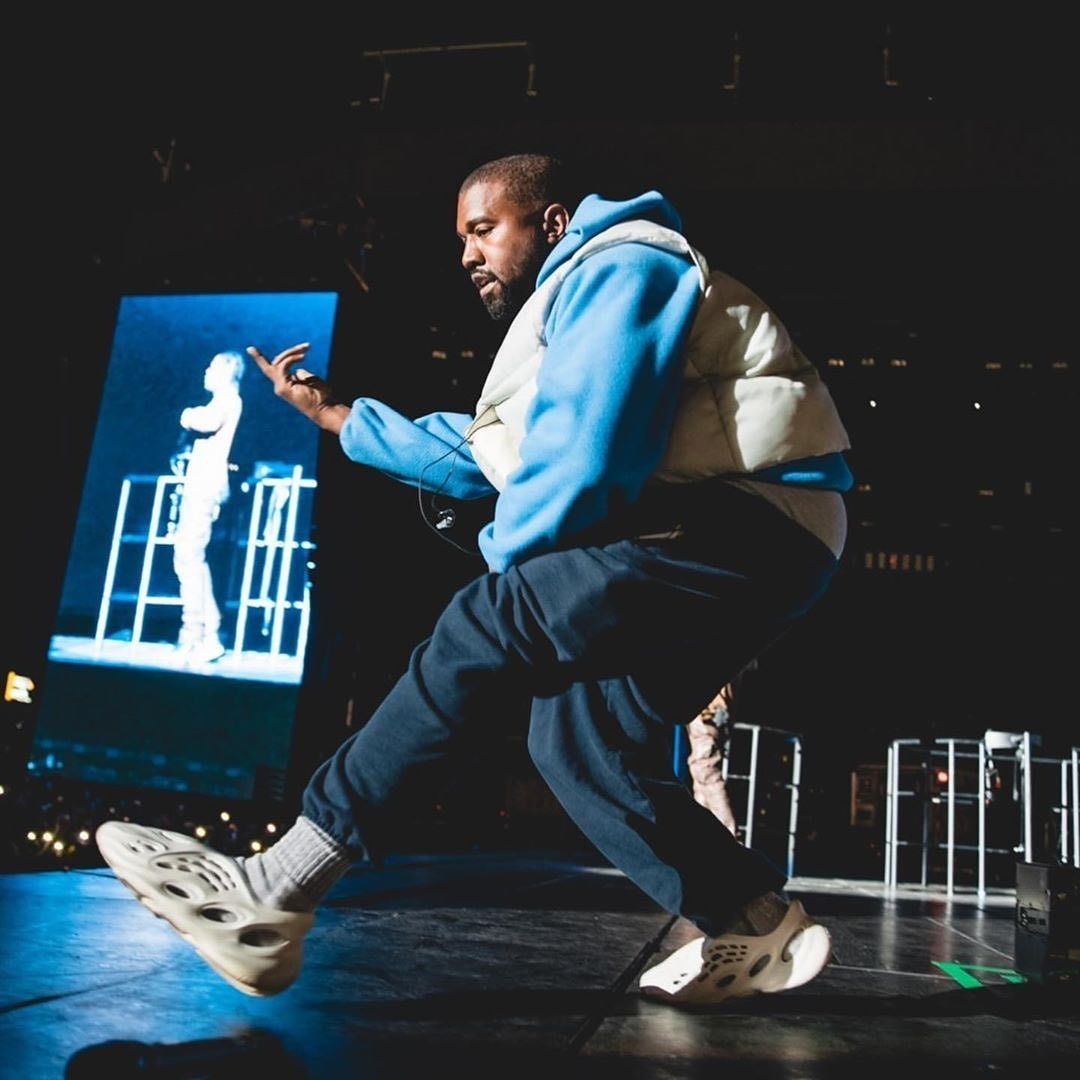 Ye took Foam Runners to Astroworld seven months before they dropped. Ye on stage at Astroworld Festival, 9 Nov 2019, in a blue hoodie, gilet and pre-release Foam Runners.