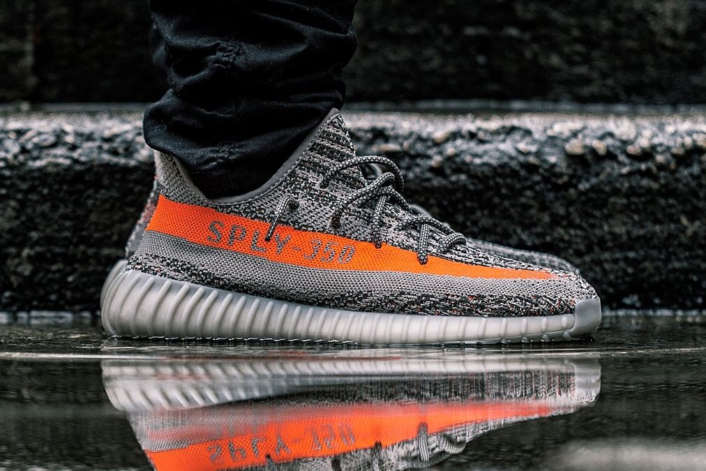 Stormzy wore the Beluga 2.0 early, and adidas’s VP called them 100% real. Beluga, on foot, grey knit with the orange SPLY-350 stripe.