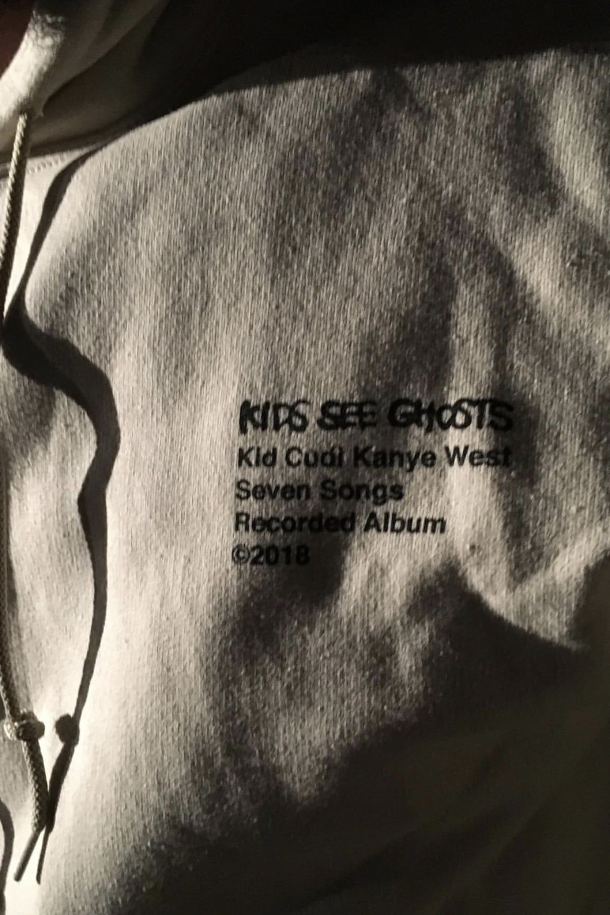 The Kids See Ghosts hoodie prints its own credits: Murakami’s art, Virgil’s layout. The chest text: KIDS SEE GHOSTS, Kid Cudi, Kanye West, Seven Songs, Recorded Album, ©2018.