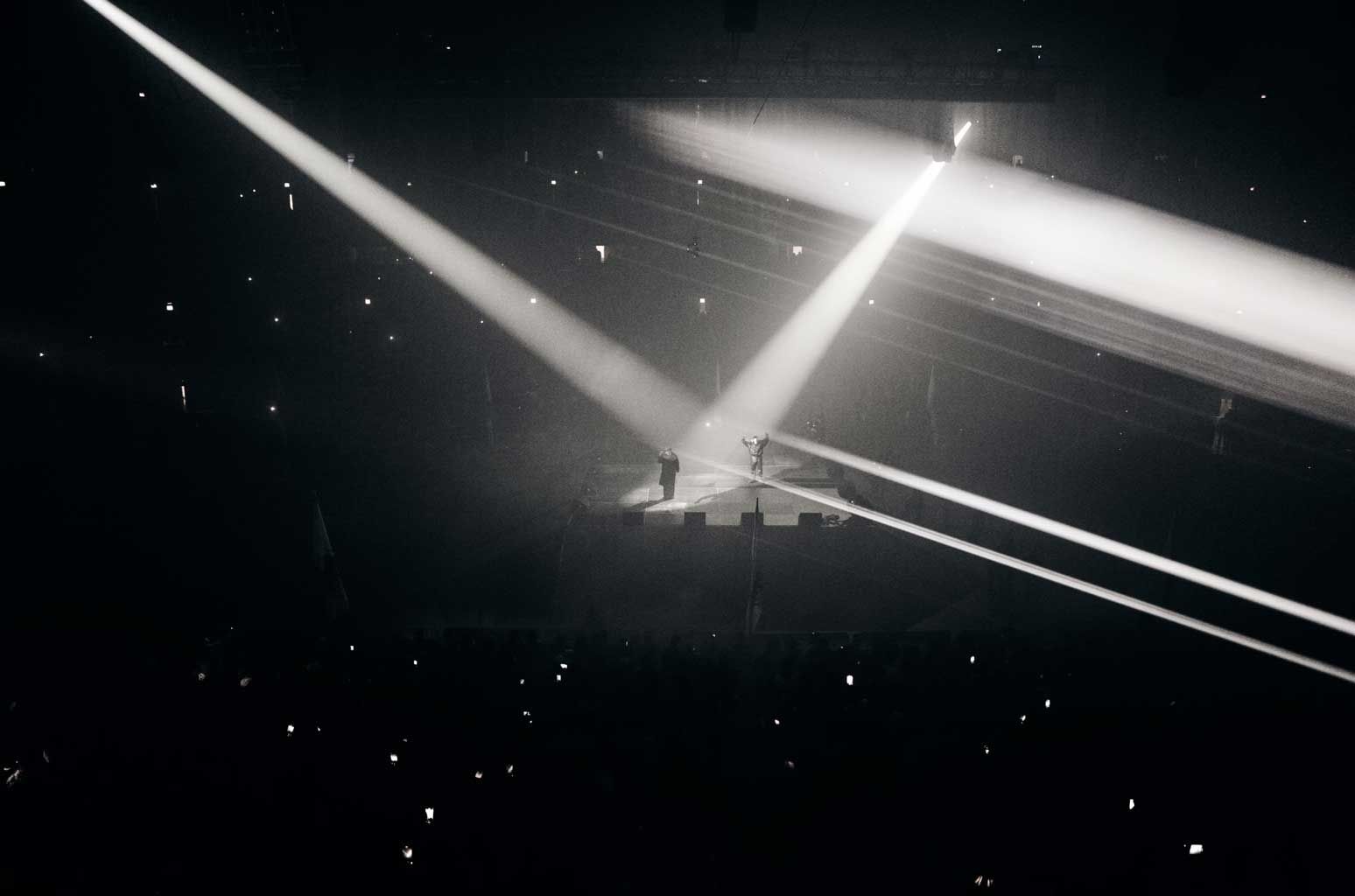 Ye played Vultures to his hometown in a hockey mask and never said a word. The United Center from the stands, light beams crossing the stage, 8 Feb 2024.