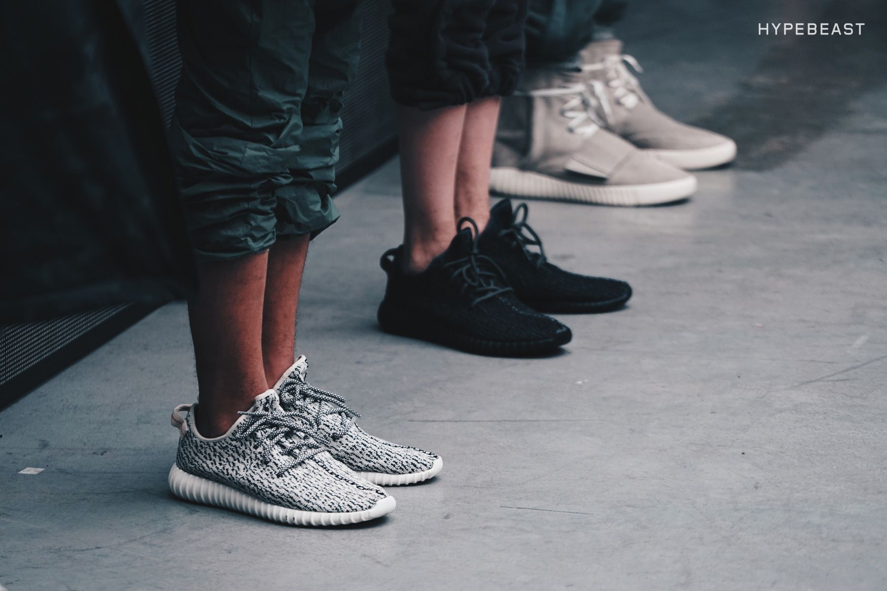 Yeezy Season 1 had Beyoncé front row. Ye bowed in a plain hoodie.. Yeezy Boost 350 in Turtle Dove and in black, and the 750 Boost, on models' feet at Yeezy Season 1, 12 Feb 2015.