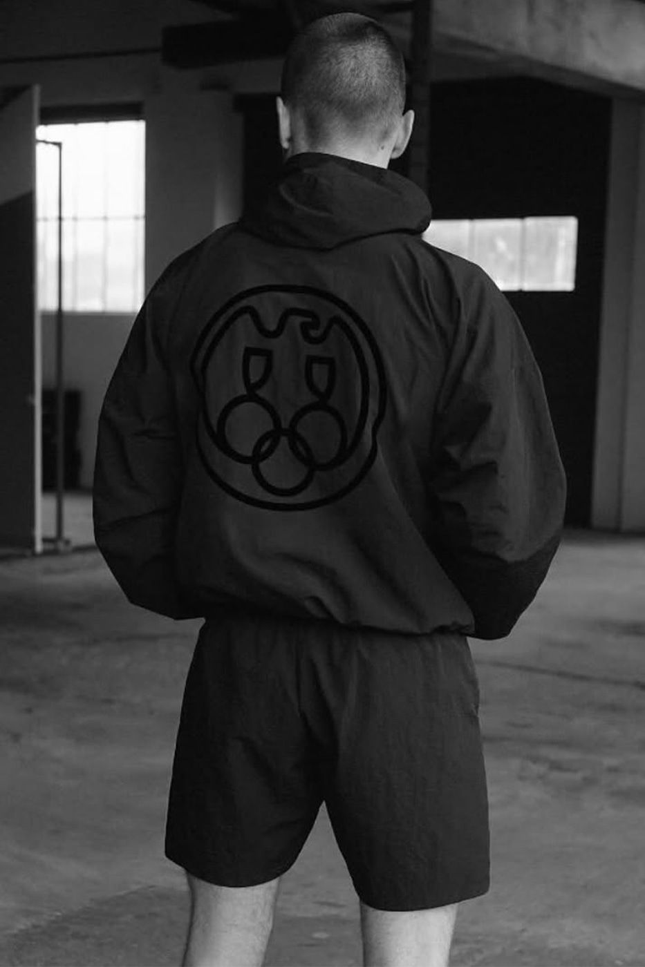 Ye wore the Herald Tribune down one leg in Tokyo, two months early. Charcoal, WB-01 windbreaker and SH-01 shorts, YZY campaign.