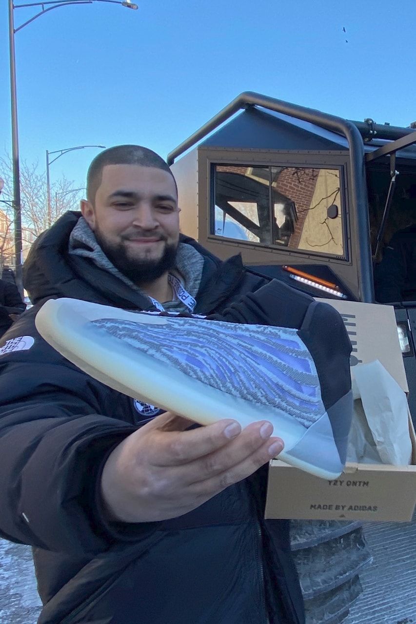 The Quantum Frozen Blue kept the reflective heel the NBA wouldn’t clear. A fan holds up a free QNTM in the first colourway in front of one of the giveaway trucks, Chicago, 14 Feb 2020.