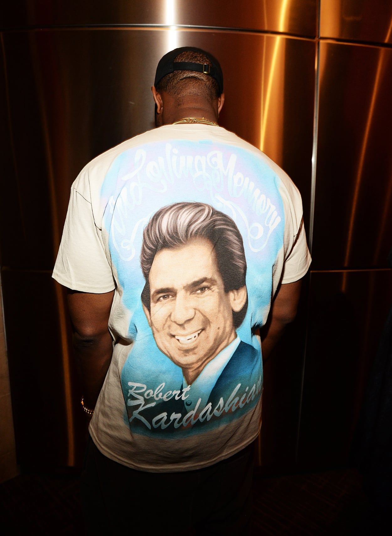 Ye sold out Madison Square Garden with an album nobody had heard. The back of the same tee: Robert Kardashian, airbrushed, backstage, 11 Feb 2016.