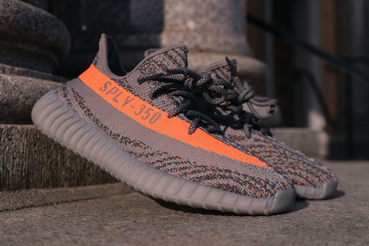 Stormzy wore the Beluga 2.0 early, and adidas’s VP called them 100% real. Beluga Reflective, pair on a stone step.