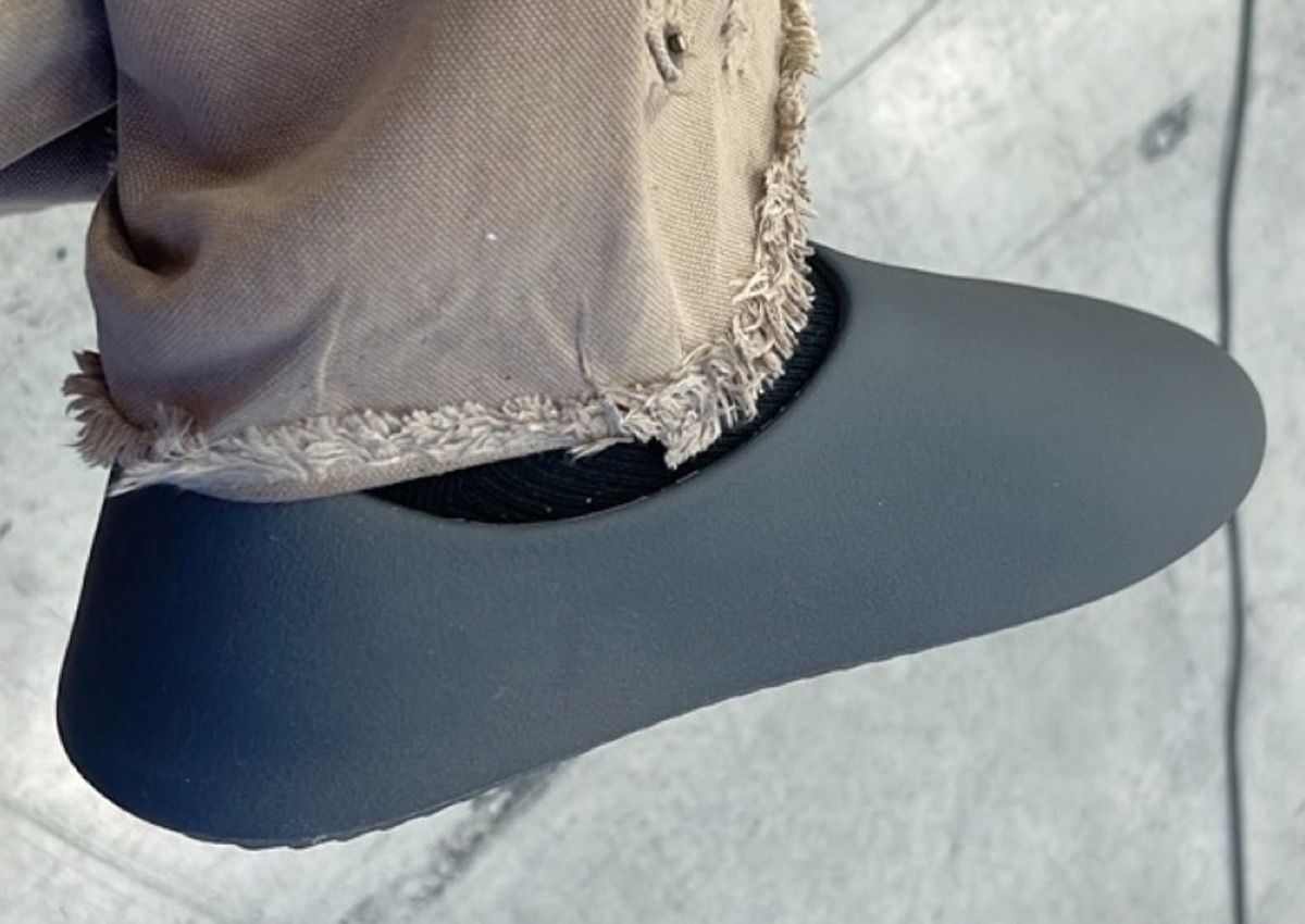 Ye’s $20 SL-01 had no logo. A week later he nicknamed it the Yeezy Slides.. Grey, on Ye's foot, frayed khaki hem, Ye's own photo.
