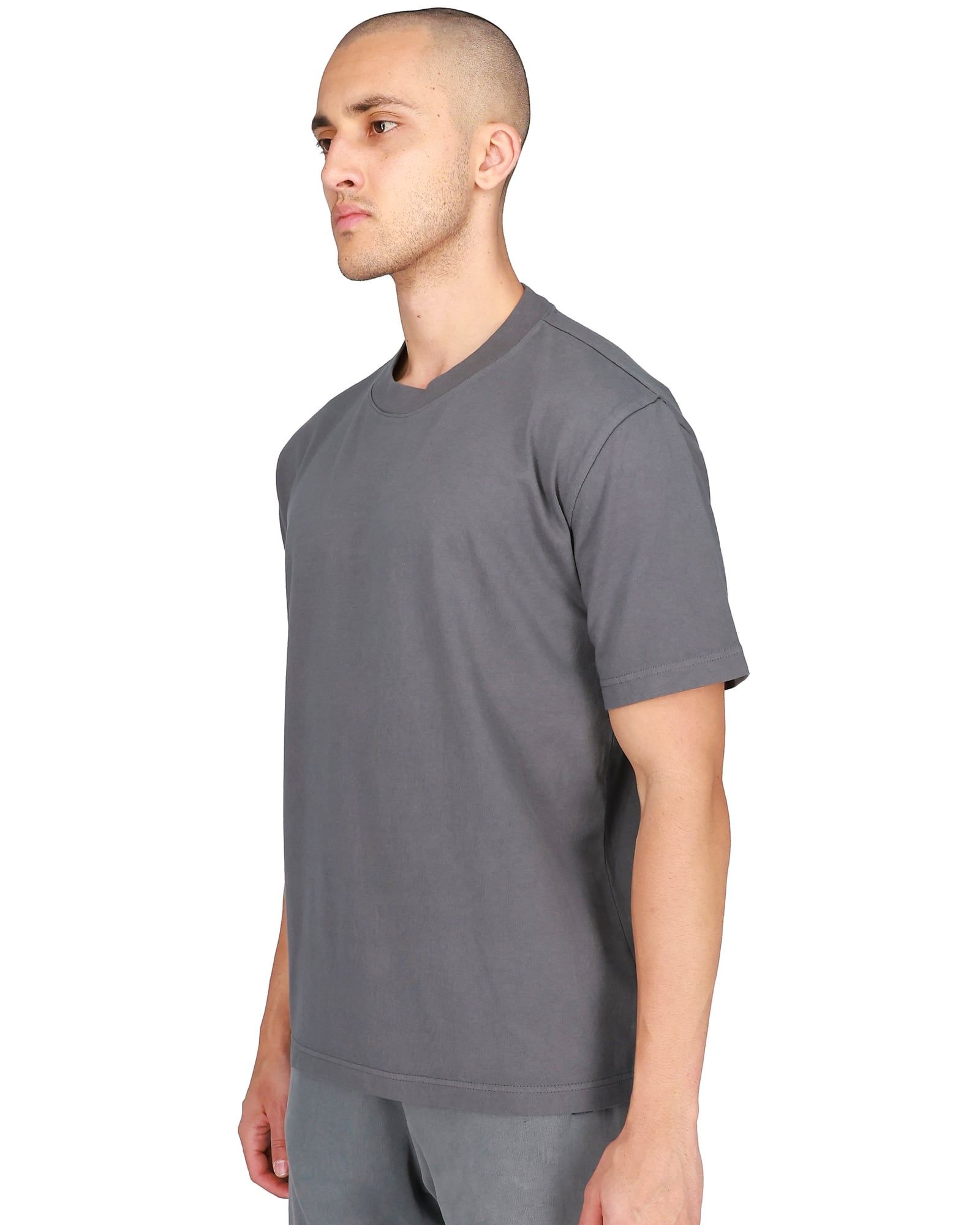 Ye’s store sold a plain tee in 2024. Its SKU started with YZYGAP. Dark grey, three-quarter view, on a model, yeezy.com listing shot.